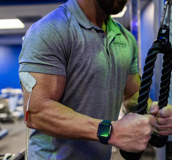 Close-up of NXPro pad on tricep during cable training